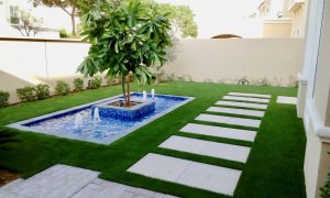 Artificial lawn next to water feature
